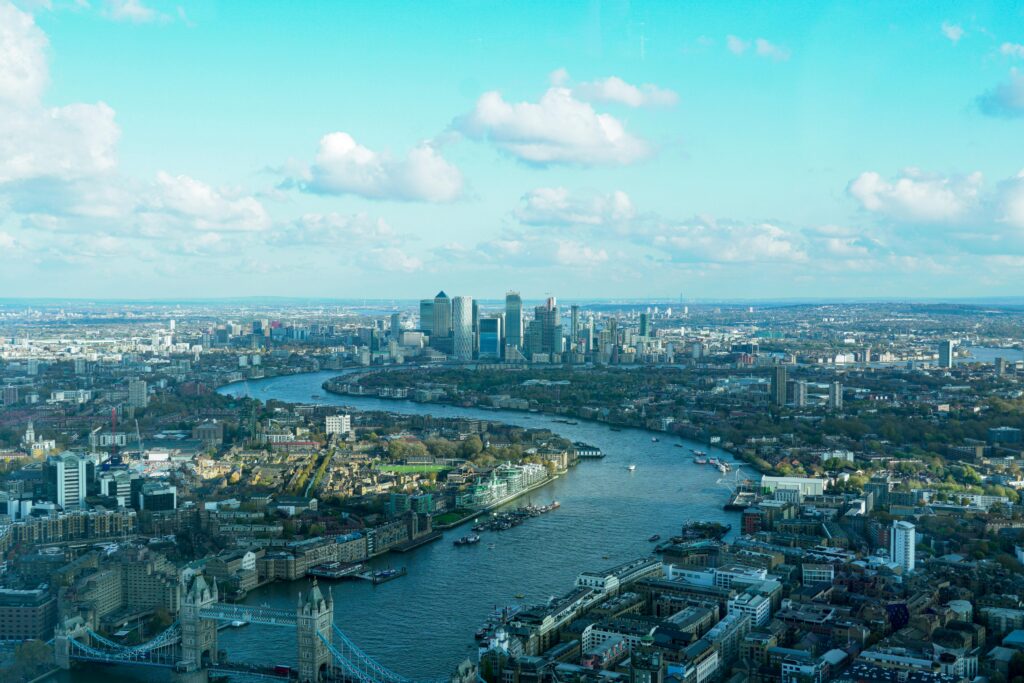 Discover the stunning aerial view of London's cityscape, highlighting the River Thames and iconic skyline.